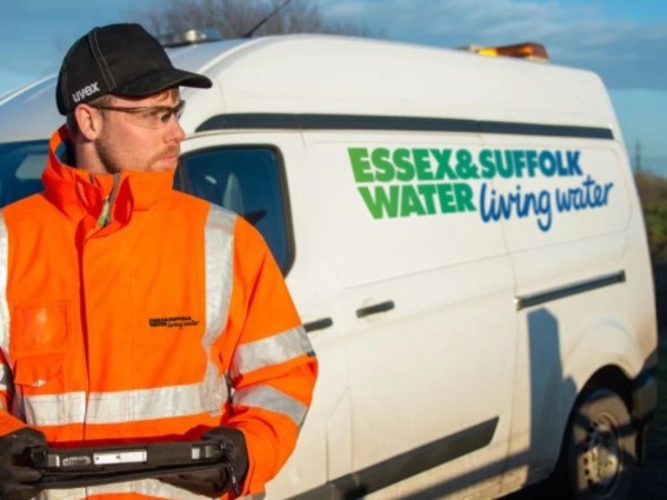 Essex & Suffolk Employee standing next to van